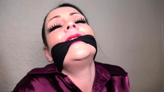 Evil Emma bound and gagged in satin and leather
