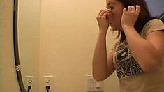 Gorgeous teen puts her make up on before heading out to party